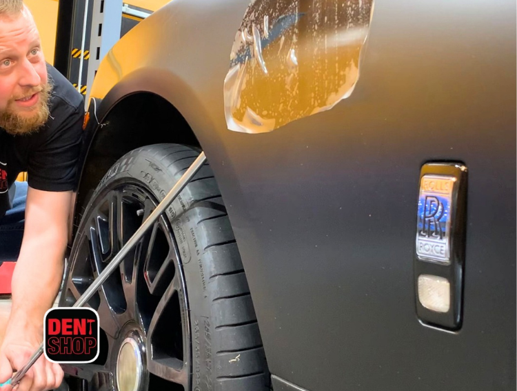 dent shop technician working on rolls-royce