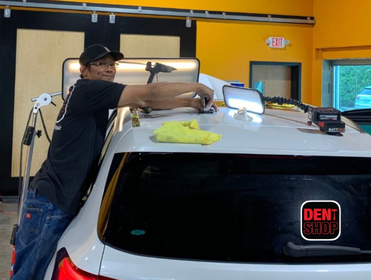 dent shop employee working on vehicle